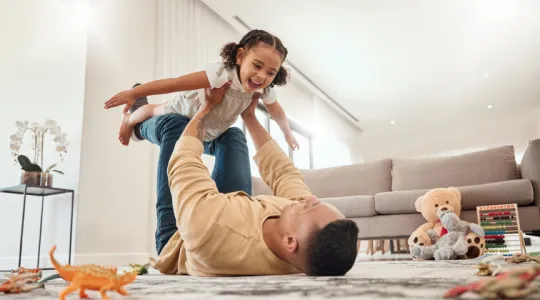 Happy family, father and girl playing in a house | Merry Maids