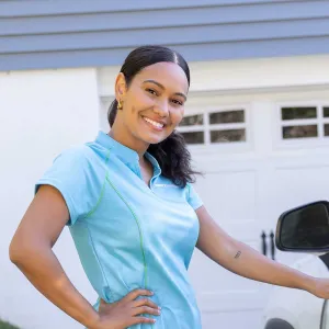Merry Maids team member next to car