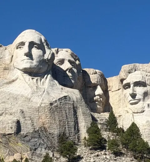 Mount Rushmore is a national monument in South Dakota featuring the carved faces of four U.S. presidents—George Washington, Thomas Jefferson, Theodore Roosevelt, and Abraham Lincoln—symbolizing the nation’s history, growth, and leadership.